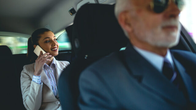 Beautiful business woman is working in car